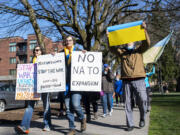 Protesters chant, hold signs and walk around Esther Short Park on Sunday during a rally to support Ukraine.