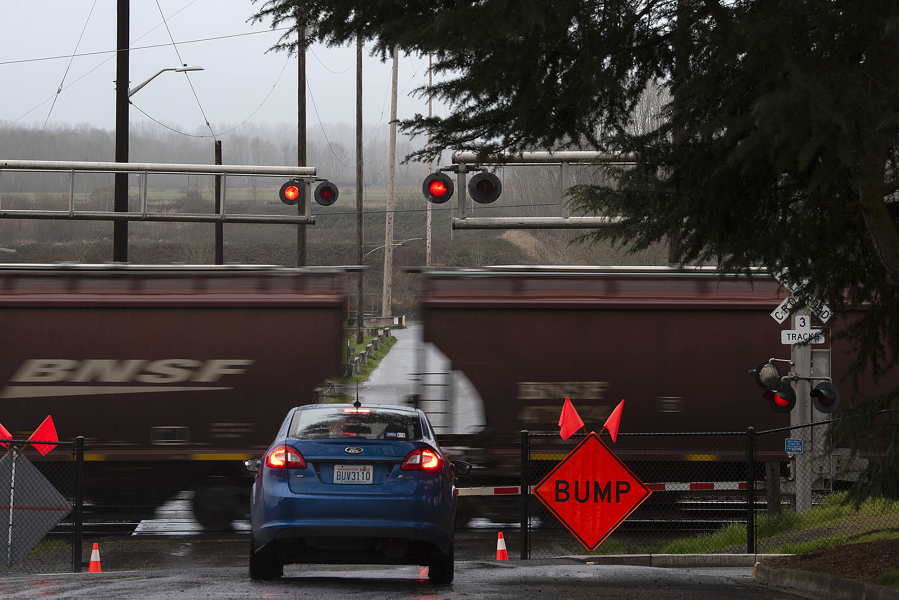 A motorist stops at the Division Street railroad crossing in Ridgefield as a construction sign is seen near the tracks.