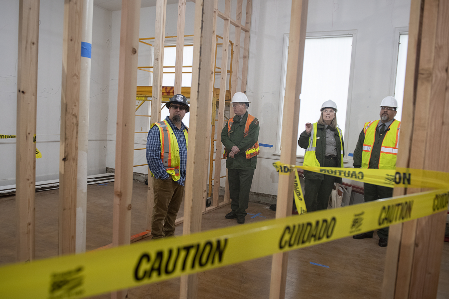 Lance Thielen of Pacific Tech Construction, left, joins National Park Service archaeologist Doug Wilson, Fort Vancouver National Site Superintendent Tracy Fortmann and National Park Service Director Chuck Sams during a tour of Building 993 on Wednesday.
