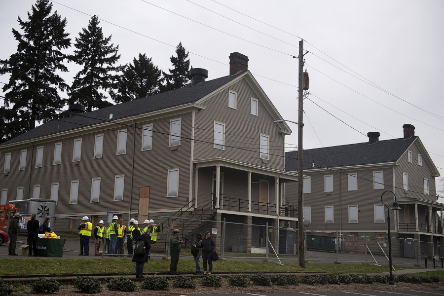 Officials and members of the media gather outside Building 993 during a press conference and tour at Fort Vancouver National Historic Site on Wednesday morning.