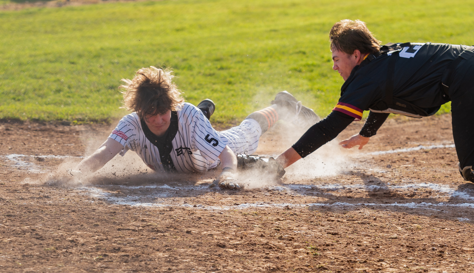 Battle Ground's Carter Hotchkiss beats the tag from Prairie's Colin Schiller in a 4A/3A Greater St. Helens League baseball game on Thursday, March 24, 2022, at Prairie High School. Battle Ground won 2-0.