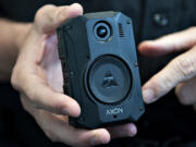 Camas Police Chief Mitch Lackey points out the features of a body camera Thursday afternoon at the Camas Police Department. The agency estimates implementing the program departmentwide by the end of April.