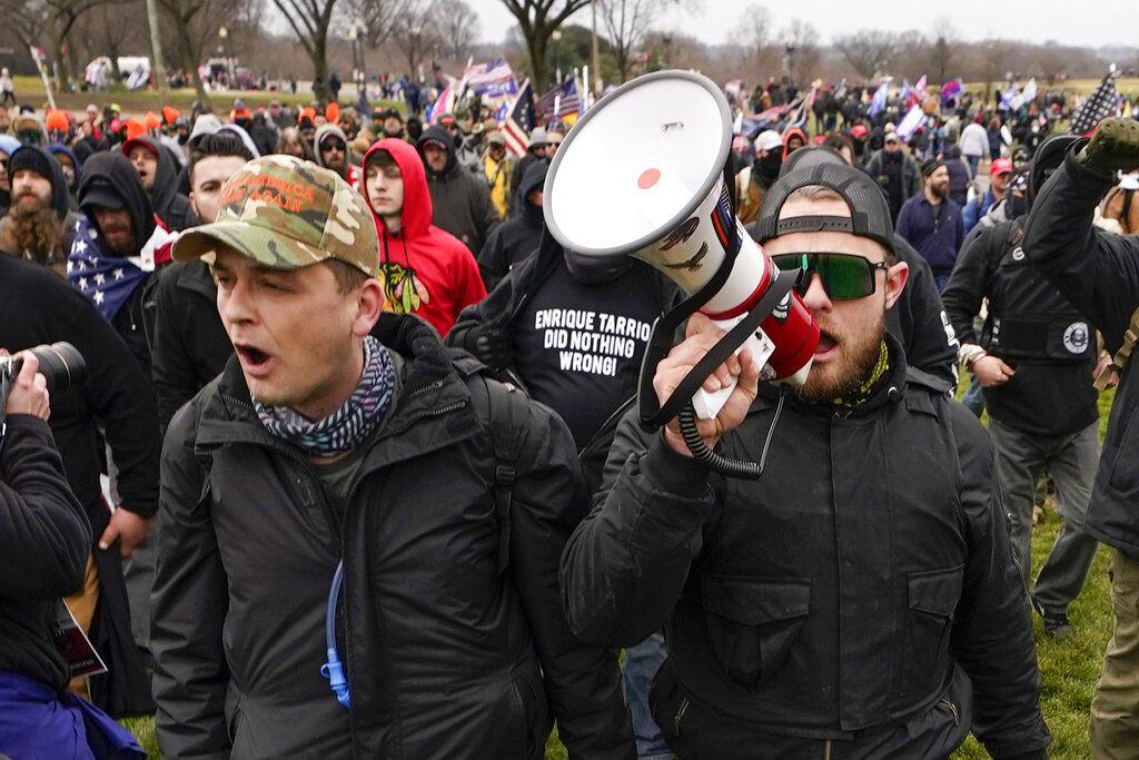 Proud Boys members Zachary Rehl, left, and Ethan Nordean of Auburn, left, walk toward the U.S. Capitol in Washington, in support of President Donald Trump.