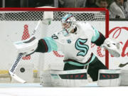 Seattle Kraken goaltender Chris Driedger deflects a shot during the first period of an NHL hockey game against the Los Angeles Kings Monday, March 28, 2022, in Los Angeles. (AP Photo/Mark J.