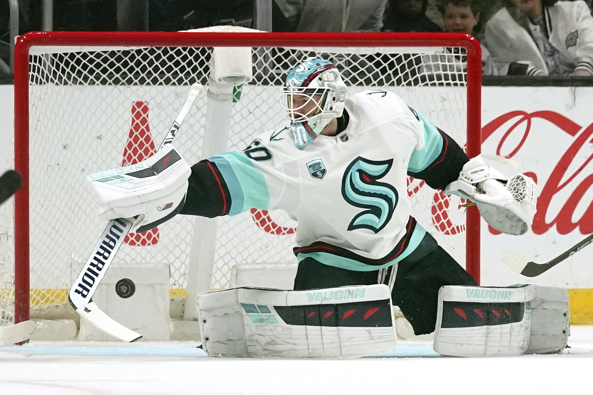 Seattle Kraken goaltender Chris Driedger deflects a shot during the first period of an NHL hockey game against the Los Angeles Kings Monday, March 28, 2022, in Los Angeles. (AP Photo/Mark J.
