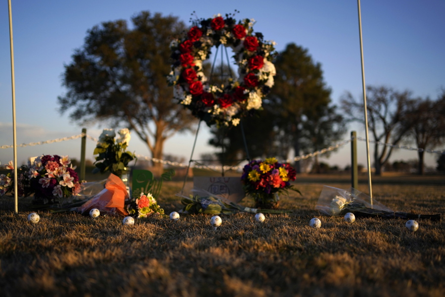 Golf balls adorn a makeshift memorial at the Rockwind Community Links, Wednesday, March 16, 2022, in Hobbs, New Mexico. The memorial was for student golfers and the coach of University of the Southwest killed in a crash in Texas.