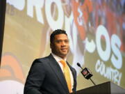 Denver Broncos new starting quarterback Russell Wilson speaks during a news conference Wednesday, March 16, 2022, at the team's headquarters in Englewood, Colo.