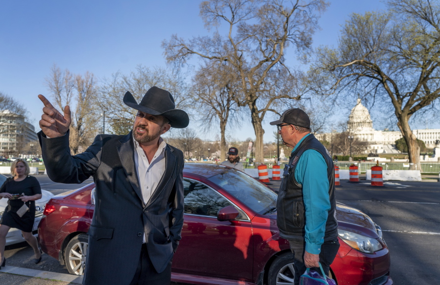 Otero County Commissioner Couy Griffin gestures before getting into a car after the first day of his trial in federal court in Washington, Monday, March. 21, 2022. Griffin is charged with illegally entering Capitol grounds the day a pro-Trump mob disrupted certification of Joe Biden's presidential election victory on Jan. 6, 2021.