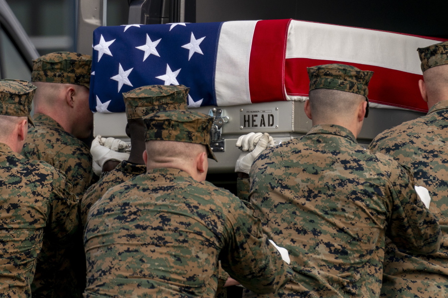 A U.S. Marine Corps carry team moves a transfer case containing the remains of Capt. Ross A. Reynolds of Leominster, Mass., into a transfer vehicle during a casualty return, Friday, March 25, 2022, at Dover Air Force Base.