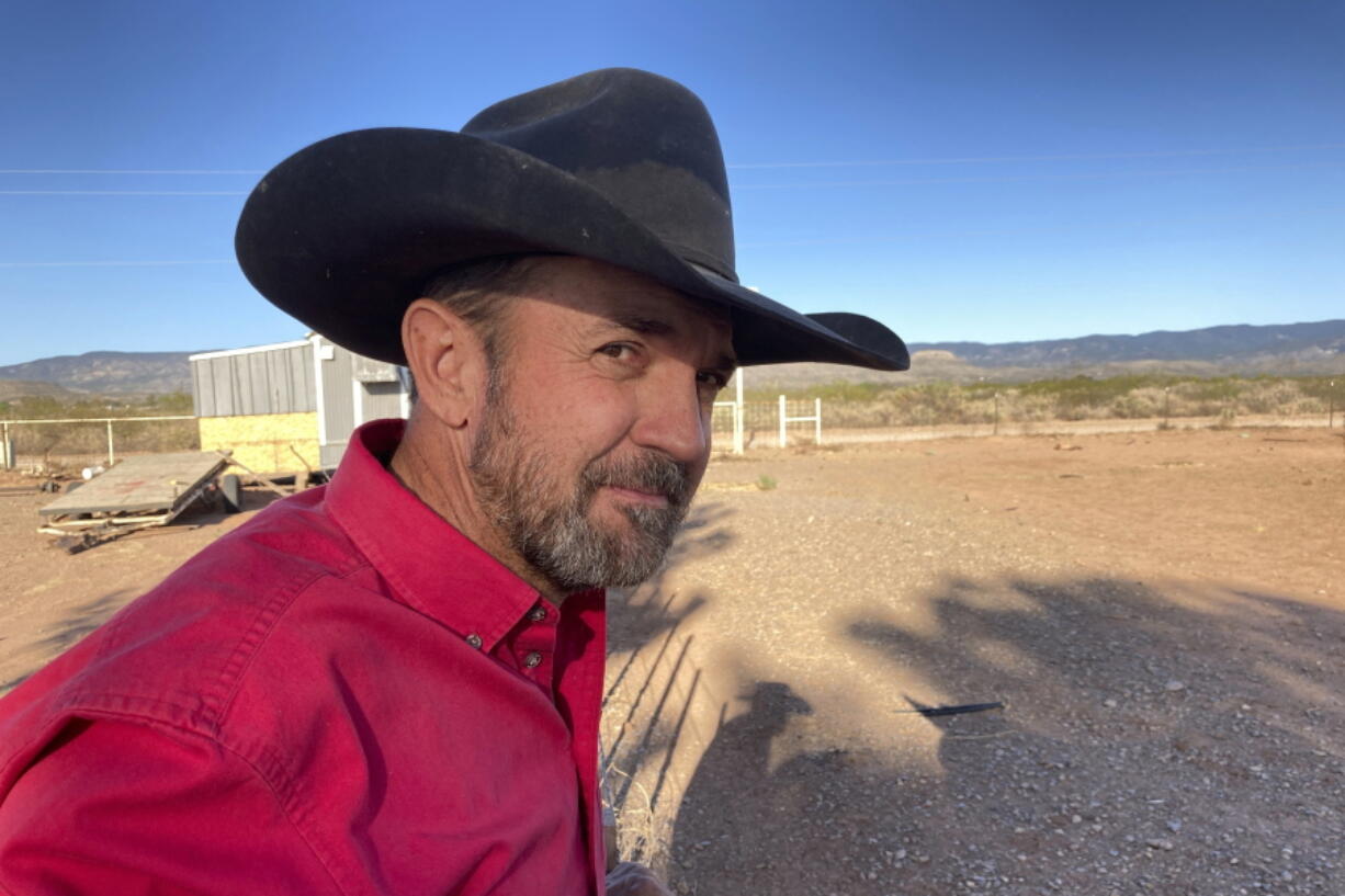 FILE - Otero County Commissioner Couy Griffin, the founder of Cowboys for Trump, takes in the view from his ranch in Tularosa, N.M., May 12, 2021. Griffin who helped found the group Cowboys for Trump is headed to trial in Washington next week on a charge related to the violent insurrection at the U.S. Capitol. And he plans to show up for court on horseback in a defiant show of support to the former president.