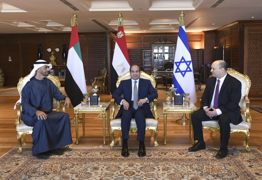 In this photo provided by the Egyptian Presidency Media Office, Egyptian President Abdel-Fattah el-Sissi, center, meets with Abu Dhabi Crown Prince Sheikh Mohammed bin Zayed Al Nahyan, left, and Israeli Prime Minister Naftali Bennett in the Red Sea resort of Sharm el-Sheikh, Egypt, Tuesday, March 22, 2022.
