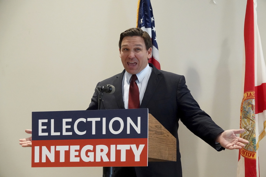 FILE - Florida Gov. Ron DeSantis asks the crowd "How about Virginia," as he arrives at an event in West Palm Beach, Fla., to announce proposed election reform laws, Wednesday, Nov. 3, 2021.  Republicans promoting claims of widespread voter fraud in at least two politically important states are turning to a new tactic to appease voters who falsely believe the 2020 presidential election was stolen: election police. The efforts in Florida and Georgia to establish law enforcement units dedicated to investigating voting or election crimes come as Republican lawmakers and governors move to satisfy the millions of voters in their party who believe former President Donald Trump's false claims that widespread voter fraud cost him re-election.