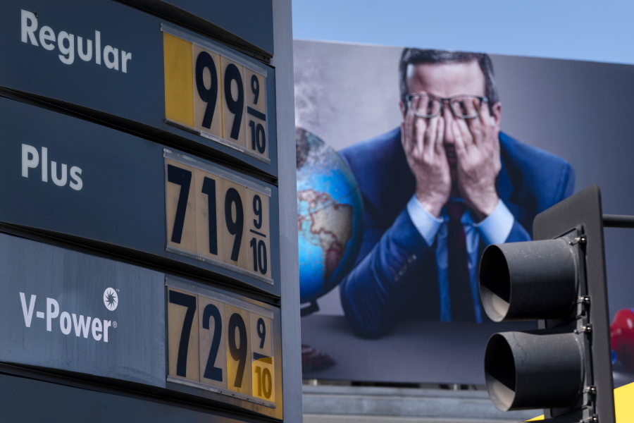 Gas prices are seen in front of a billboard advertising HBO's Last Week Tonight in Los Angeles, Monday, March 7, 2022. The average price for a gallon of gasoline in the U.S. hits a record $4.17 on Tuesday as the country prepares to ban Russian oil imports.  (AP Photo/Jae C.