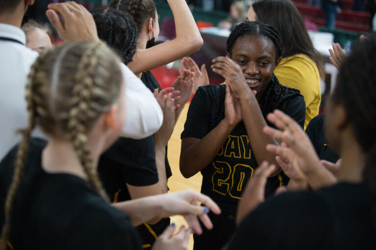 Hudson's Bay’s Devon Johnson-Brown (20) celebrates with teammates after a 54-53 win over West Valley of Spokane at the Class 2A girls basketball state tournament on Friday, March 4, 2022 in Yakima.