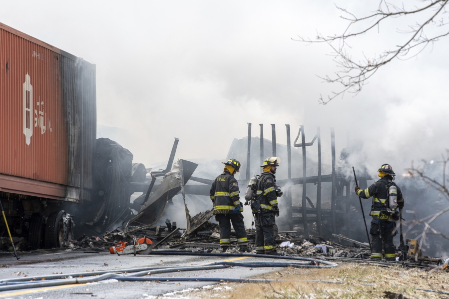 Firefighters work at the scene of a multi-vehicle crash on Interstate 81 North near the Minersville exit in Foster Township, Pa., Monday, March 28, 2022.