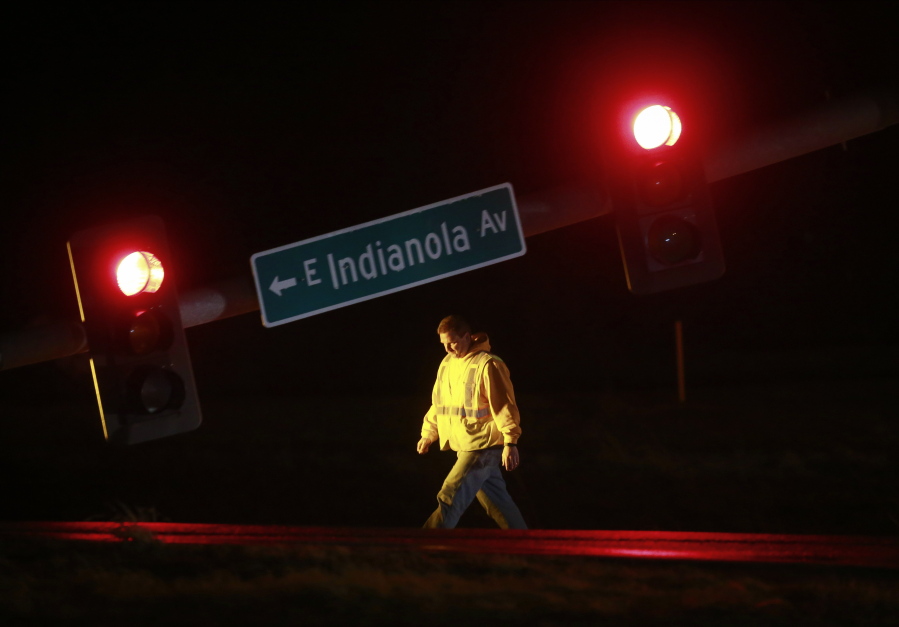 A utility worker tends to a downed stoplight on Highway 69 in Des Moines, Iowa, on Saturday, March 5, 2022, after a strong storm caused damage in areas of central Iowa.