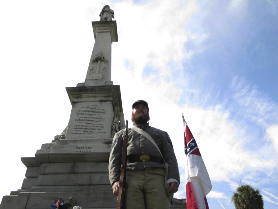 FILE - In this July 10, 2017 file photo, Cameron Maynard stands at attention by the monument to Confederate soldiers at the South Carolina Statehouse in Columbia, S.C.  A bill giving state employees in South Carolina a floating holiday to replace Confederate Memorial Day is heading to the Senate floor. The bill started as a proposal to add the Juneteenth celebration on June 19 as a new state holiday.