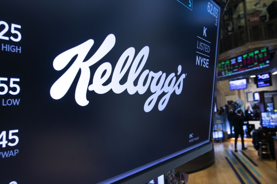 FILE - The logo for Kellogg's appears above a trading post on the floor of the New York Stock Exchange, Tuesday, Oct. 29, 2019.   Several hundred workers at a Kellogg's plant that makes Cheez-Its won a new contract that delivers more than 15% wage increases over three years after 1,400 workers at the company's cereal plants went on strike for nearly three months last fall. The union that represents those 570 workers in Kansas City, Kansas said Wednesday, March 30, 2022, that the wages and benefit improvements secured this week are the biggest ones the local union has ever seen.