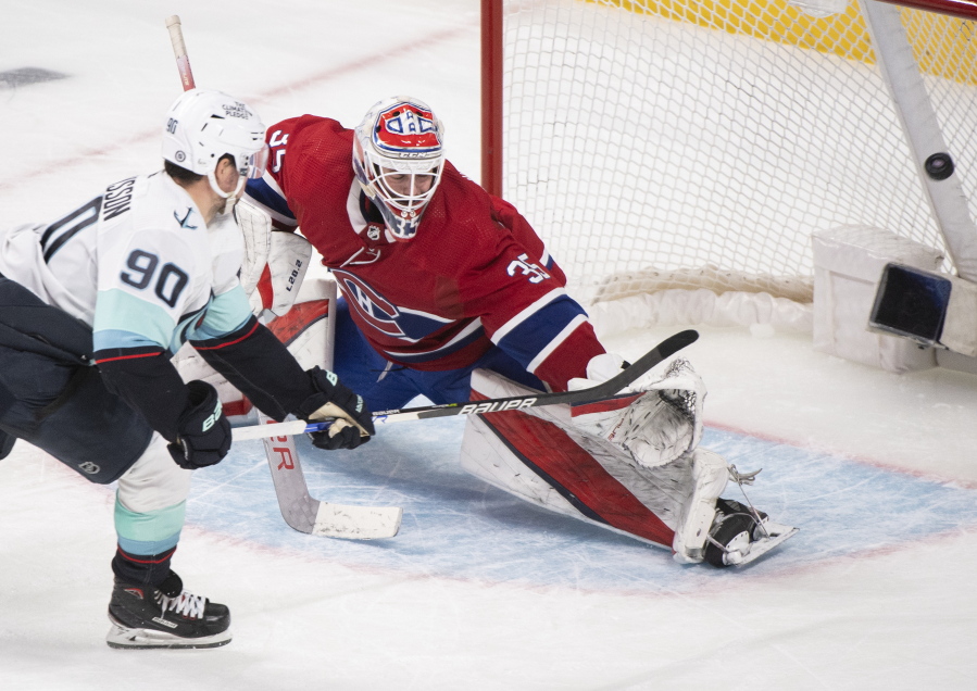 Seattle Kraken's Marcus Johansson (90) scores against Montreal Canadiens goaltender Sam Montembeault, right, during shootout NHL hockey action in Montreal, Saturday, March 12, 2022.