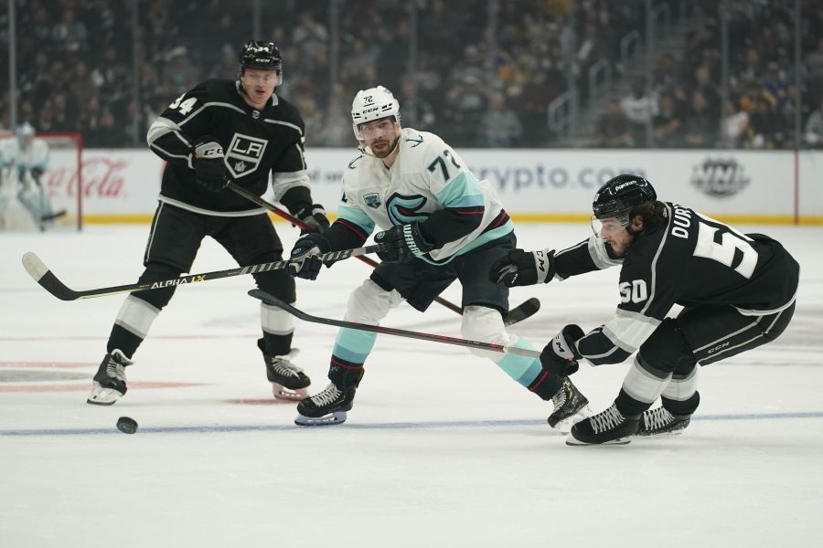 Seattle Kraken right wing Joonas Donskoi (72) passes against Los Angeles Kings right wing Arthur Kaliyev (34) and defenseman Sean Durzi (50) during the first period of an NHL hockey game Saturday, March 26, 2022, in Los Angeles.