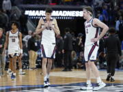 Gonzaga guard Hunter Sallis (10), center Chet Holmgren, middle, and forward Drew Timme react after Gonzaga was defeated by Arkansas in a college basketball game in the Sweet 16 round of the NCAA tournament in San Francisco, Thursday, March 24, 2022.