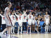 Players on the Gonzaga bench cheer for Gonzaga forward Drew Timme, left, during the second half of a first round NCAA college basketball tournament game against Georgia State, Thursday, March 17, 2022, in Portland, Ore.