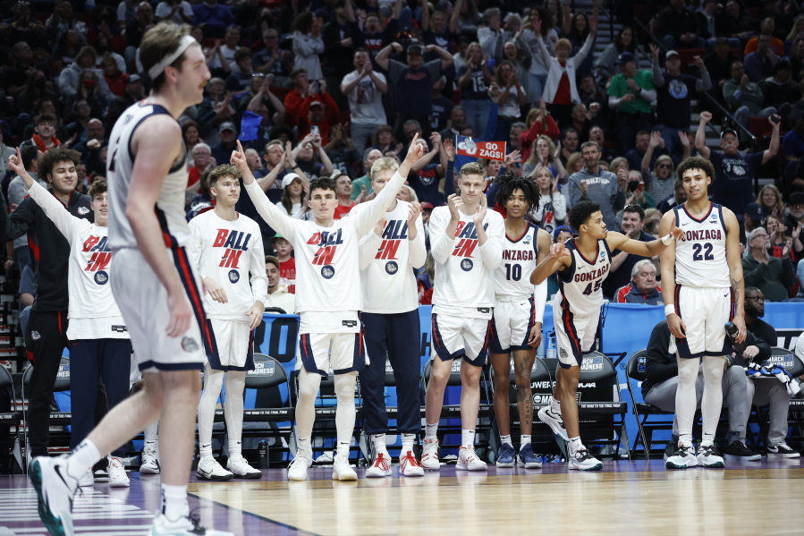 Players on the Gonzaga bench cheer for Gonzaga forward Drew Timme, left, during the second half of a first round NCAA college basketball tournament game against Georgia State, Thursday, March 17, 2022, in Portland, Ore.