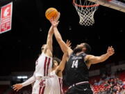 Washington State guard Tyrell Roberts (2) grabs a rebound over Santa Clara forward Keshawn Justice (14) during the second half of an NCAA college basketball game in the NIT on Tuesday, March 15, 2022, in Pullman, Wash.