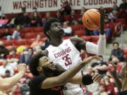 Oregon State forward Maurice Calloo, left, and Washington State forward Mouhamed Gueye go after a rebound during the second half of an NCAA college basketball game Thursday, March 3, 2022, in Pullman, Wash. Washington State won 71-67.