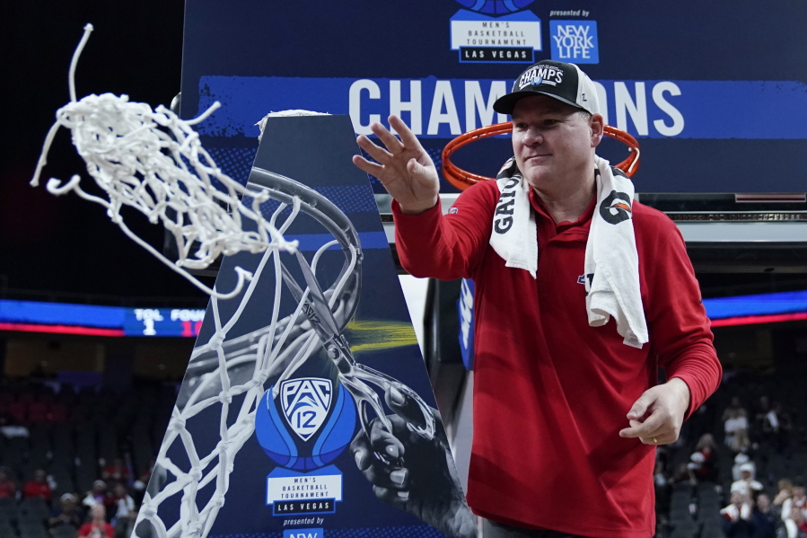 Arizona head coach Tommy Lloyd, a 1993 graduate of Kelso High School, cuts down the net after winning the Pac-12 Conference Tournament.