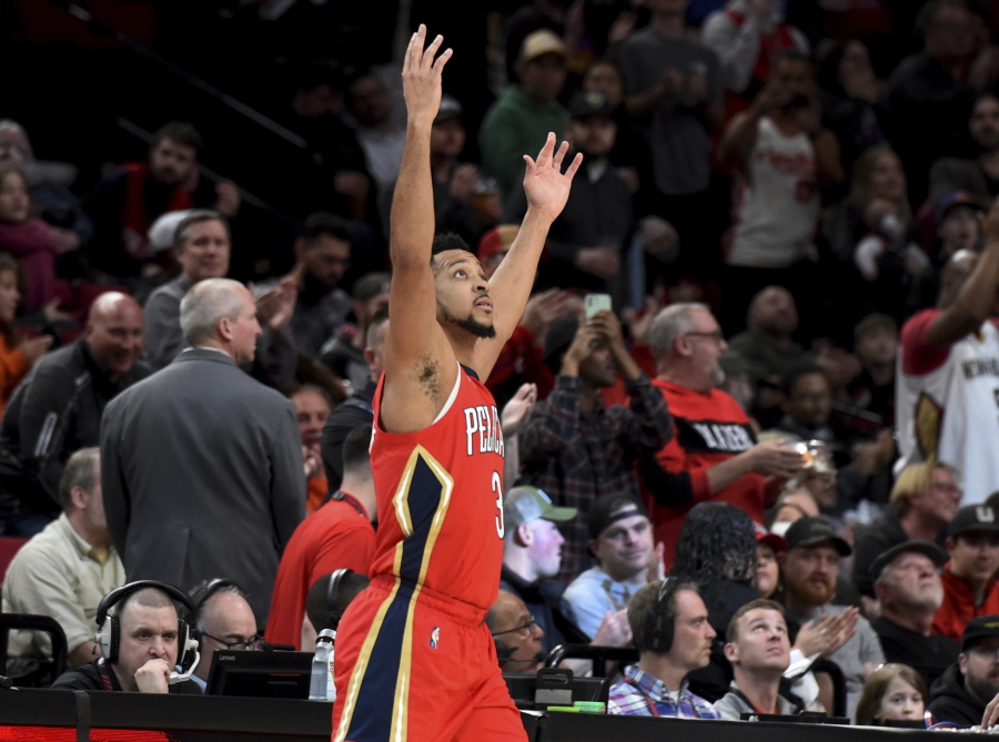 New Orleans Pelicans guard CJ McCollum reacts to the fans as he enters the game after a timeout in which a highlight video of him as a Portland Trail Blazer was played, during the first half of an NBA basketball game in Portland, Ore., Wednesday, March 30, 2022. It was the first game back in Portland for the longtime Blazer, who was traded to the Pelicans in February.