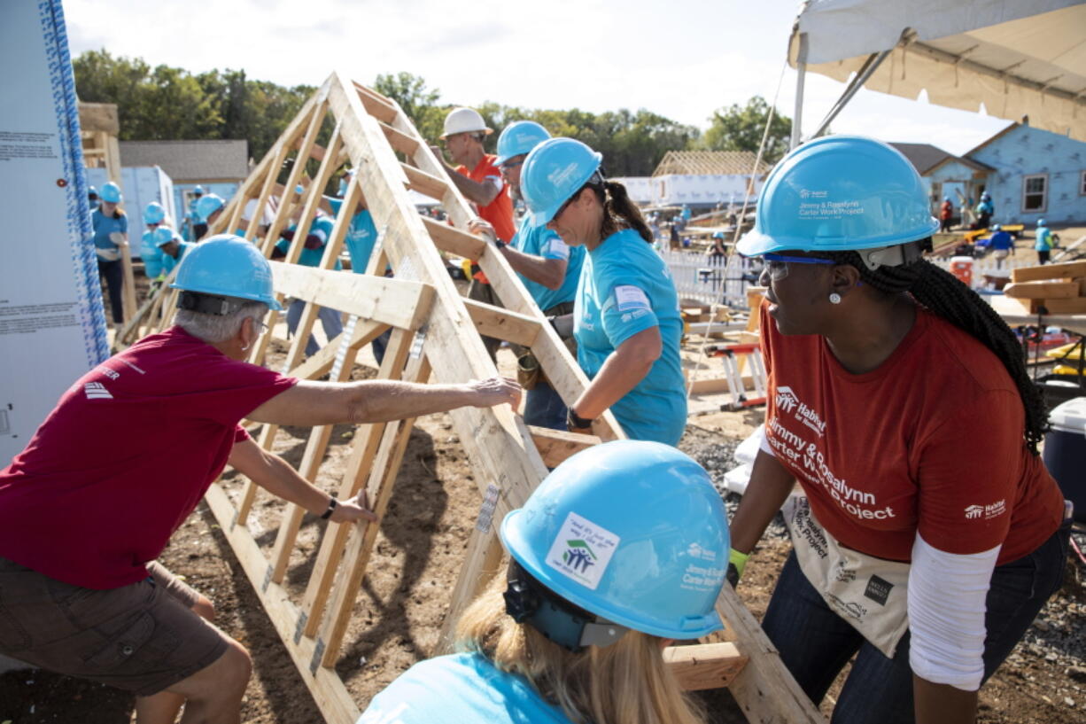 This photo provided by Habitat for Humanity International shows volunteers for Habitat for Humanity International, work on a house at the Carter Work Project in Nashville in 2019.  MacKenzie Scott donated $436 million to Habitat for Humanity International and 84 of its U.S. affiliates - the largest publicly disclosed donation from the billionaire philanthropist since she pledged to give away the majority of her wealth in 2019.