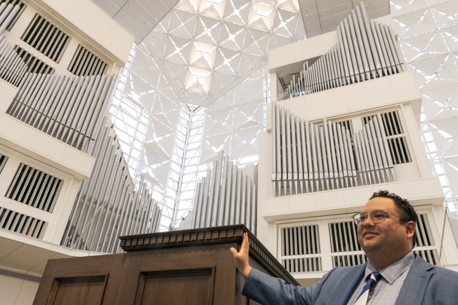 David La'O Ball, organist and head of music ministry at Christ Cathedral, stands Feb. 15 by the Hazel Wright organ in Garden Grove, Calif.