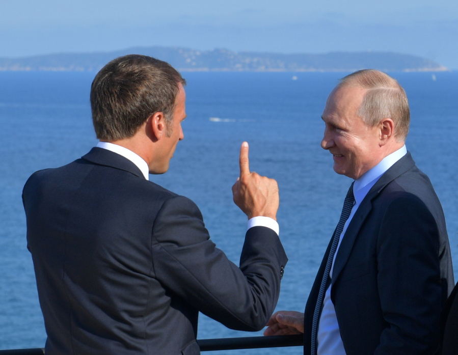 FILE - French President Emmanuel Macron, left, talks with Russian President Vladimir Putin during their meeting at the fort of Bregancon in Bormes-les-Mimosas, southern France, Monday Aug. 19, 2019.