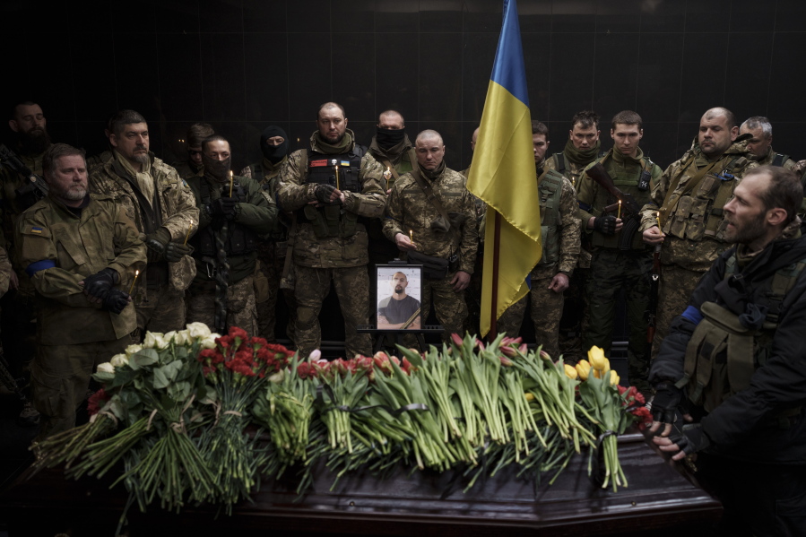 Ukrainian servicemen attend the funeral ceremony of marine Alexandr Khovtun, in Kyiv, Ukraine, Sunday, March 20, 2022. Khovtun died in combat in the town of Huta-Mezhyhirska, north of Kyiv.