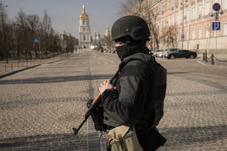 A Ukrainian serviceman stands at a checkpoint in Kyiv, Ukraine, Thursday, March 24, 2022. Ukraine President Volodymr Zelenskyy called on people worldwide to gather in public Thursday to show support for his embattled country as he prepared to address U.S. President Joe Biden and other NATO leaders gathered in Brussels on the one-month anniversary of the Russian invasion.