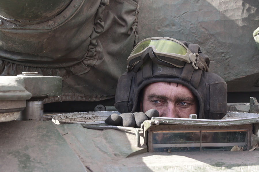 A Ukrainian serviceman looks out from a tank in the village of Lukyanivka, Kyiv region, Ukraine, Sunday, March 27, 2022.