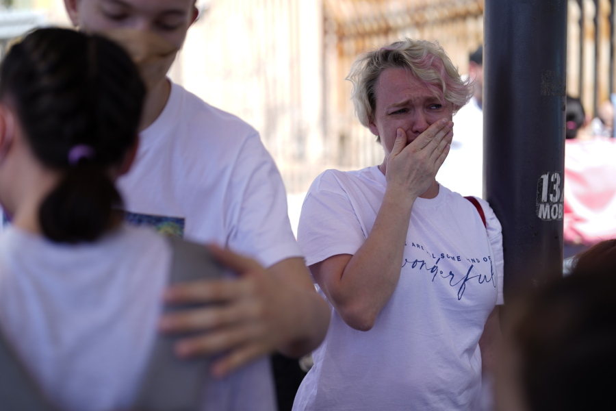 Irina Zolkina, who is seeking asylum in the United States, cries as she recalls her trip from Russia to the Mexican border, standing near the San Ysidro Port of Entry into the United States, in Tijuana, Mexico, Thursday, March 17, 2022. "It's very hard to understand how they make decisions," said Zolinka, a 40-year-old Russian woman who camped overnight with her family of seven after arriving in Tijuana on Thursday.