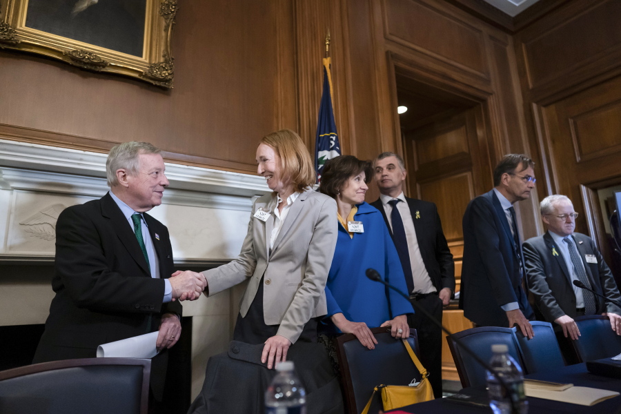 Sen. Dick Durbin, D-Ill., welcomes German Ambassador Emily Haber and other European diplomats to discuss the Russian invasion of Ukraine, at the Capitol in Washington, Thursday, March 10, 2022. (AP Photo/J.