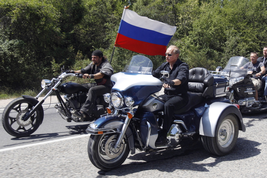 FILE - Russia's Prime Minister Vladimir Putin, foreground, rides a Harley-Davidson Lehman Trike as he arrives for the meeting with Russian and Ukrainian bikers at their camp near Sevastopol, in Ukraine's Crimea Peninsula, on July 24, 2010.  Harley-Davidson halted motorcycle shipments to Russia and said its thoughts "continue for the safety of the people of Ukraine.".