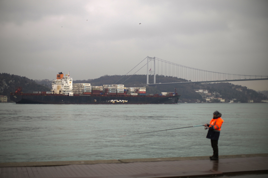 FILE - Cargo ship Oakland crosses the Bosphorus strait towards the Marmara sea after departing from Russia's Novorossiysk port, in Istanbul, Tuesday, March 1, 2022. Turkey, which is trying to balance its support for Ukraine with its fragile economic ties to Russia, said Monday it is implementing an international convention that allows the country to shut down the straits at the entrance of the Black Sea to warships, to avoid an escalation of the conflict.