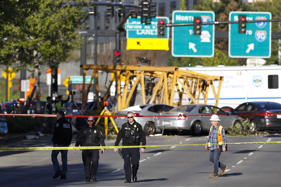 FILE- Emergency crews work at the scene of a construction crane collapse that killed four people on April 27, 2019, in the South Lake Union neighborhood of Seattle. A jury on Monday, March 14, 2022, awarded more than $150 million to some of the victims of the high-profile accident.