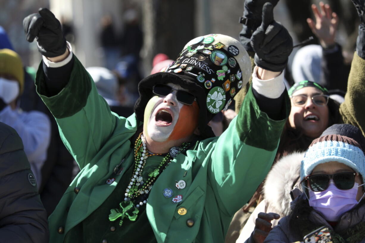 A parade goer dressed as a leprechaun yells during the St. Patrick's Day Parade along South Columbus Drive Saturday, March 12, 2022, in Chicago. (John J.