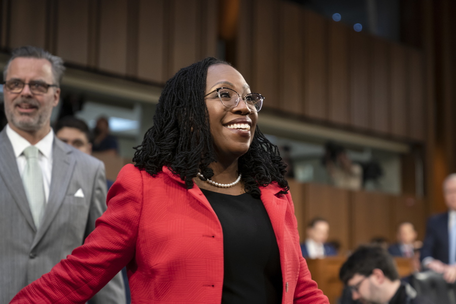 Supreme Court nominee Ketanji Brown Jackson, joined at left by her husband, Dr. Patrick Jackson, smiles as she arrives to face questions from the Senate Judiciary Committee during her confirmation hearing, on Capitol Hill in Washington, Tuesday, March 22, 2022. (AP Photo/J.