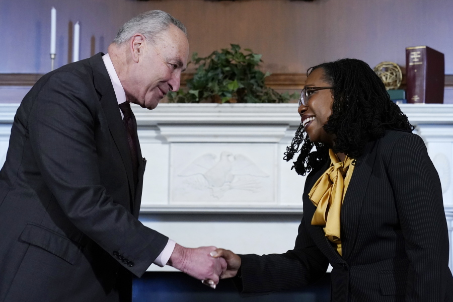 Senate Majority Leader Chuck Schumer of N.Y., left, shakes hands with Supreme Court nominee Ketanji Brown Jackson, right, at the beginning of their meeting on Capitol Hill in Washington, Wednesday, March 2, 2022.