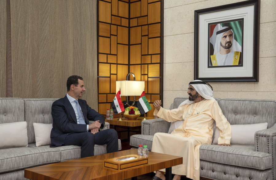 In this photo released by the official Facebook page of the Syrian Presidency, Syrian President Bashar Assad, left, meets with Sheikh Mohammed bin Rashid Al Maktoum, vice president and prime minister of the UAE and the ruler of Dubai, in Dubai, United Arab Emirates, Friday, March 18, 2022. Assad travelled to the United Arab Emirates, marking his first visit to an Arab country since Syria's civil war erupted in 2011, his office said Friday.