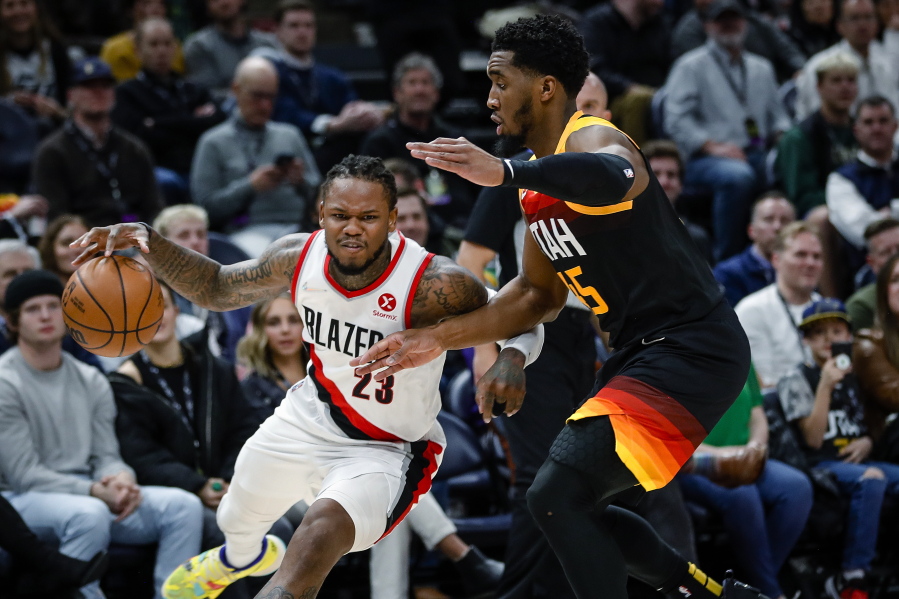 Portland Trail Blazers guard Ben McLemore (23) drives around Utah Jazz guard Donovan Mitchell (45) during the first half of an NBA basketball game Wednesday, March 9, 2022, in Salt Lake City.