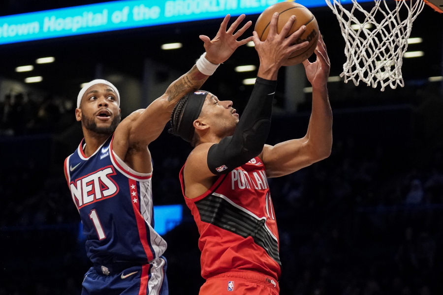 Portland Trail Blazers guard Josh Hart (11) shoots against Brooklyn Nets forward Bruce Brown (1) in the first half of an NBA basketball game, Friday, March 18, 2022, in New York.