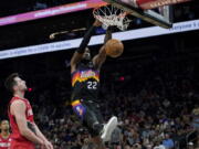 Phoenix Suns center Deandre Ayton (22) dunks against the Portland Trail Blazers during the second half of an NBA basketball game, Wednesday, March 2, 2022, in Phoenix.