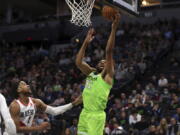 Minnesota Timberwolves center Karl-Anthony Towns (32) shoots next to Portland Trail Blazers forward Trendon Watford (2) during the first half of an NBA basketball game Saturday, March 5, 2022, in Minneapolis.